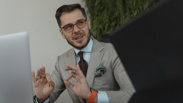 Professional businessman engaging in a discussion at his workplace, conveying confidence and leadership.