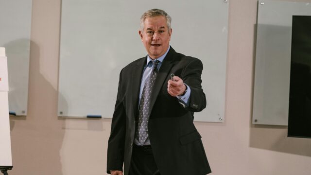 Professional presenter delivering a business talk in a conference room.