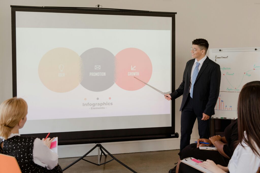 A professional presenting growth strategy with infographics during a business meeting.
